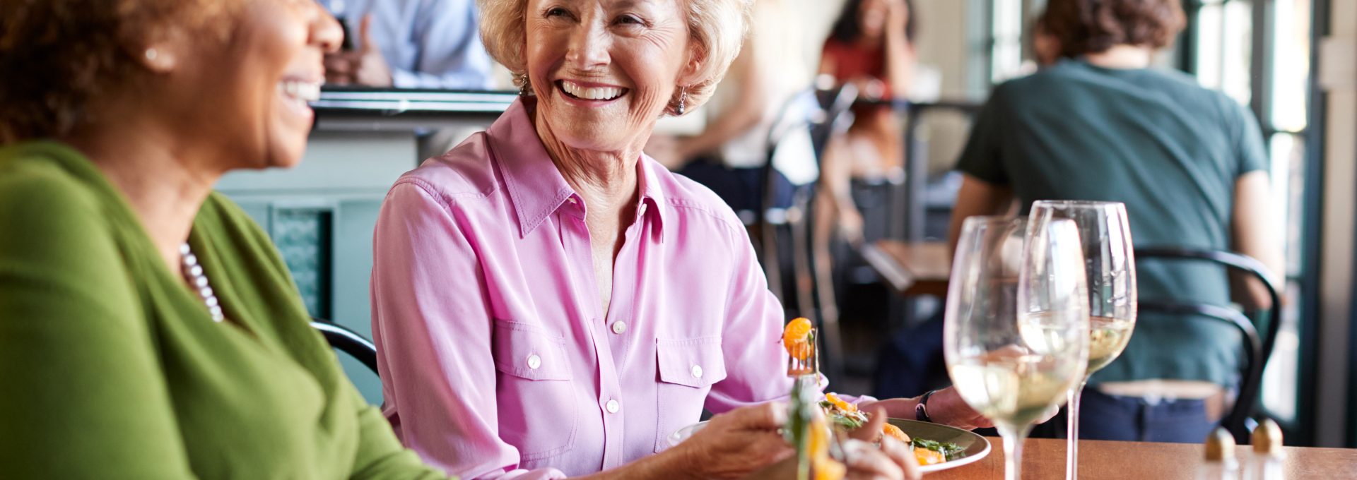 two women sitting at a table with a plate of food at The Hudson Oaks