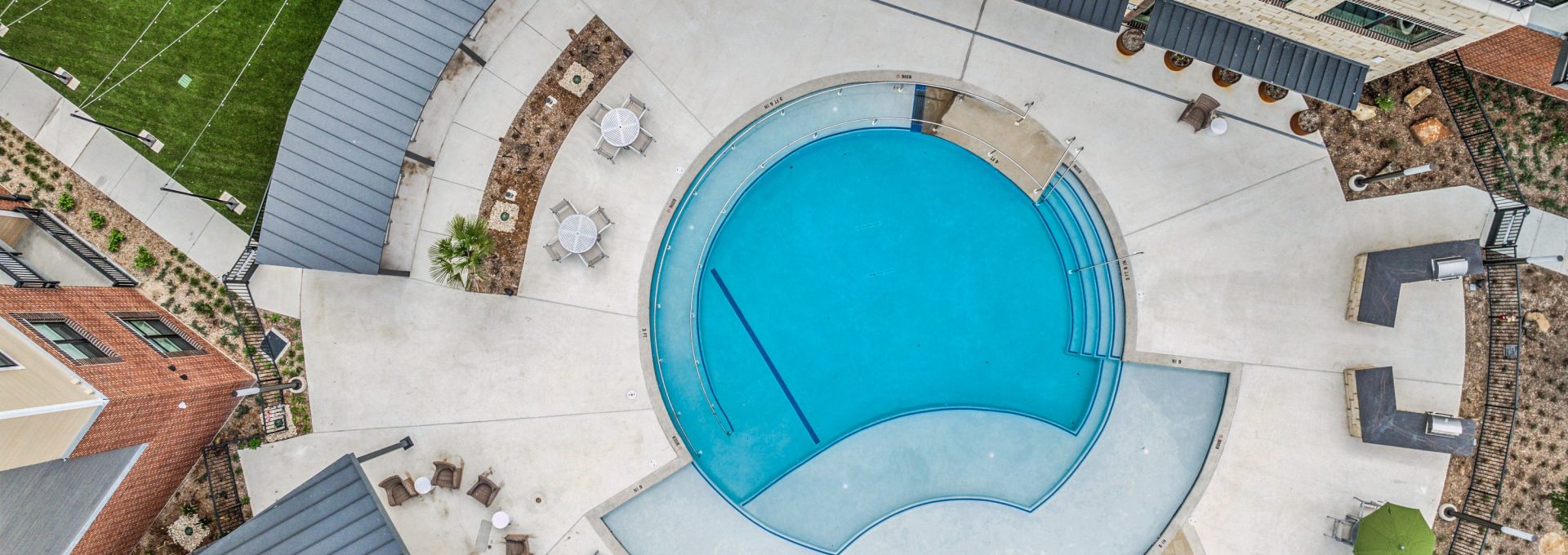 an aerial view of a pool and patio area at The Hudson Oaks