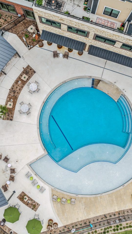 an aerial view of a pool and patio area at The Hudson Oaks