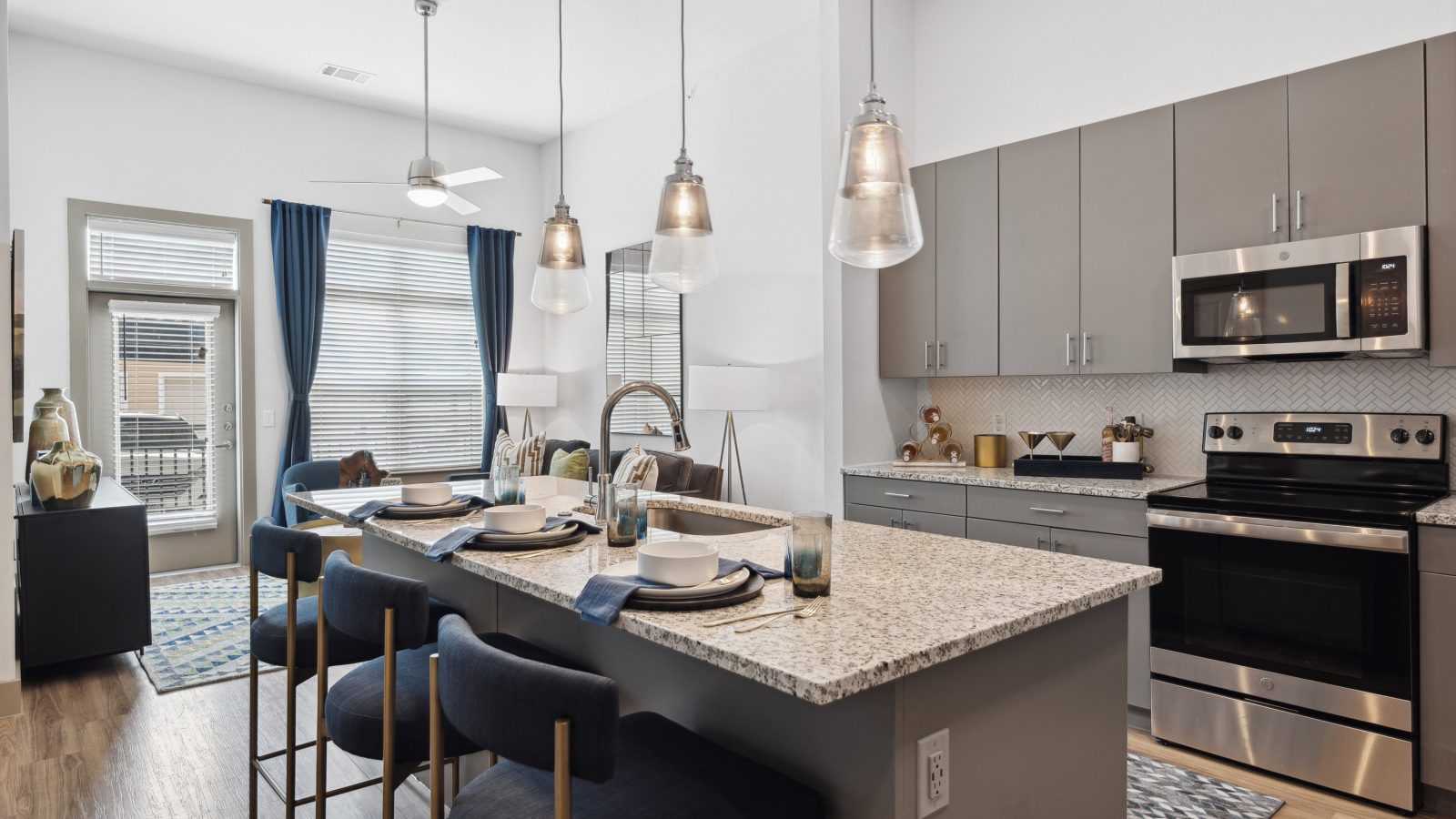 a kitchen with stainless steel appliances and granite countertops at The Hudson Oaks