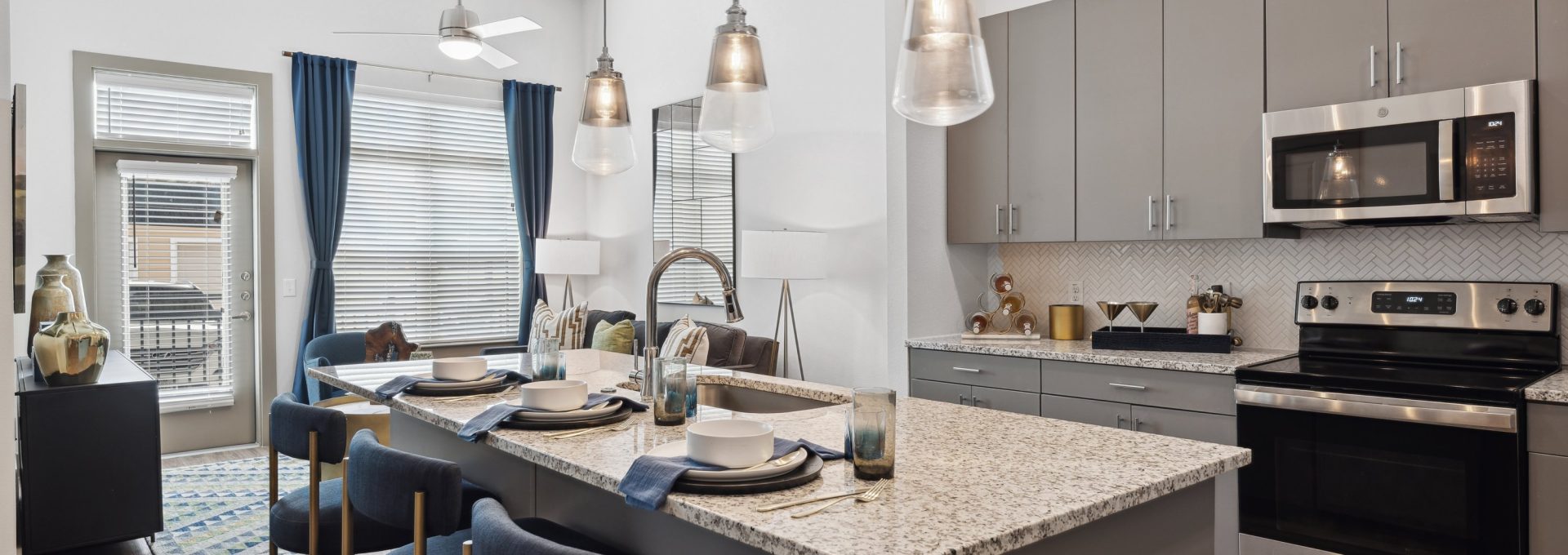 a kitchen with stainless steel appliances and granite countertops at The Hudson Oaks