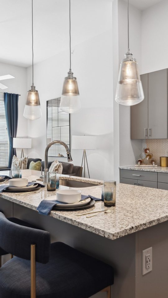 a kitchen with stainless steel appliances and granite countertops at The Hudson Oaks