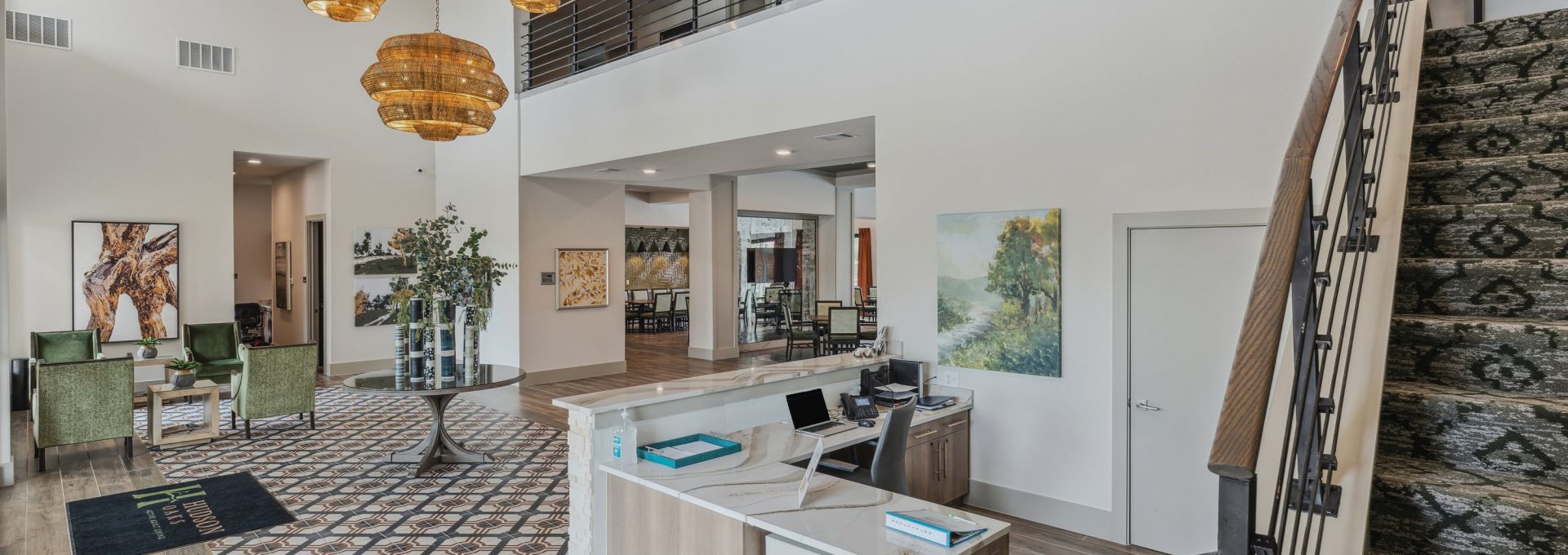 the lobby of a modern apartment building with a staircase at The Hudson Oaks